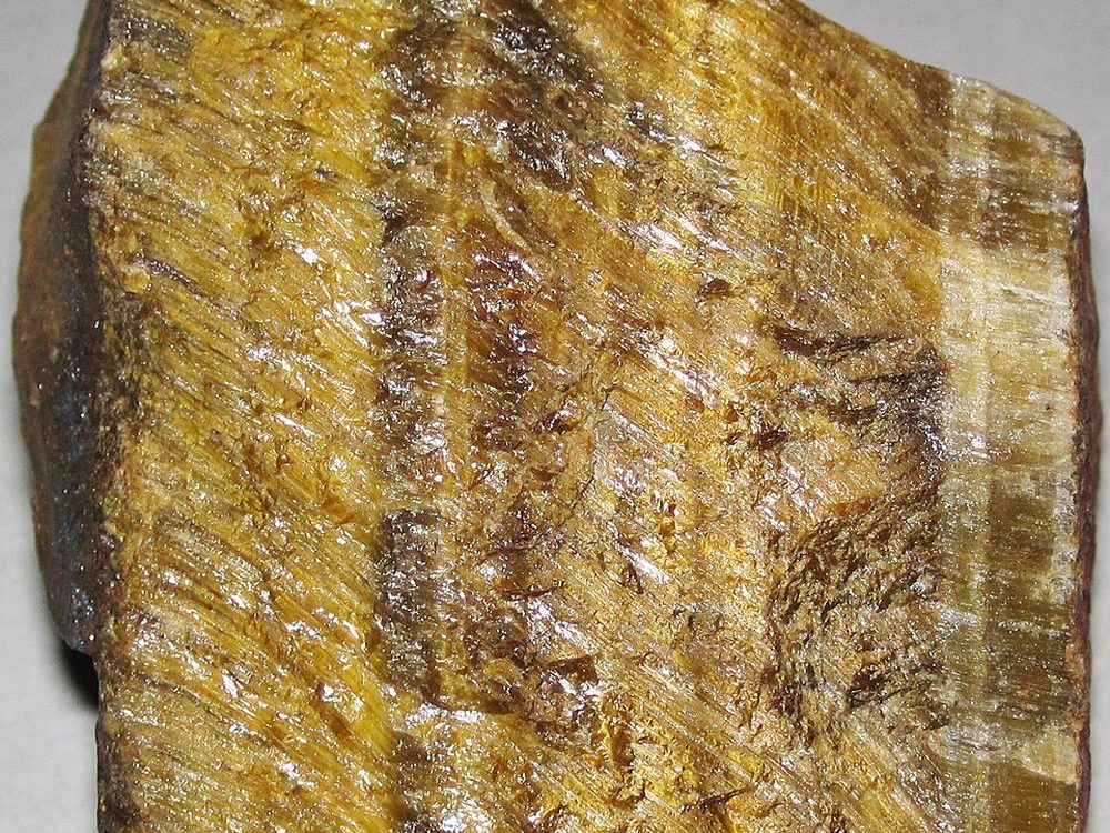 Raw tiger eye showing parallel golden banding